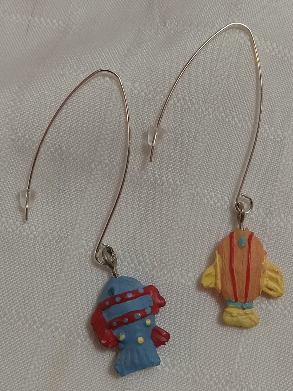 Handmade earrings featuring small, colorful fish